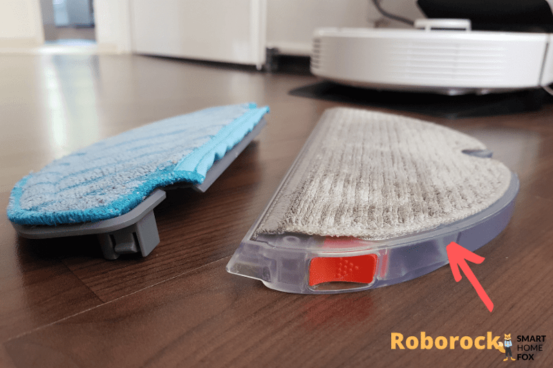 The Roborock Q7 Max+ mop lies on the floor next to a mop from a competitor product.